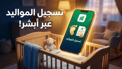 شاشة هاتف ذكي تعرض خدمة تسجيل المواليد عبر منصة أبشر بجوار سرير طفل